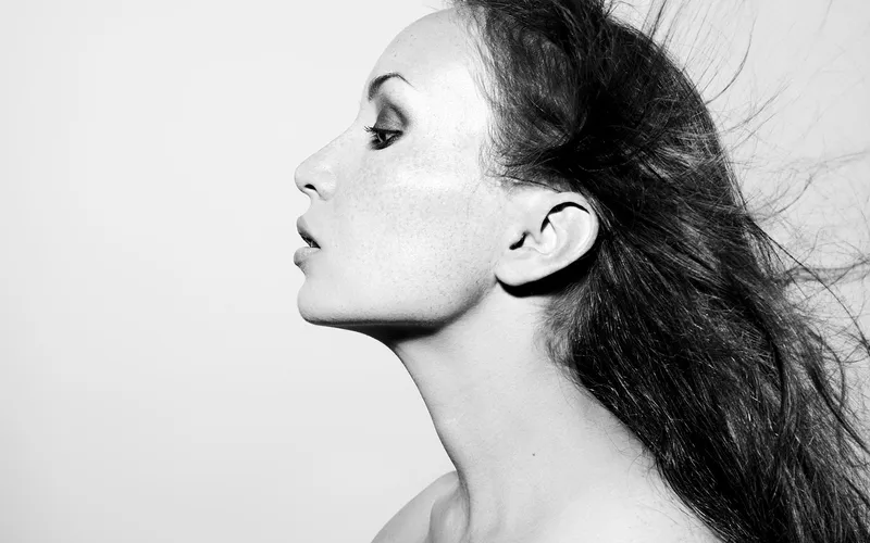 Woman's side profile highlighting ear structure for reconstruction assessment