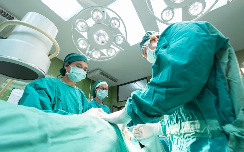 Surgical team performing tonsillectomy in modern operating theater